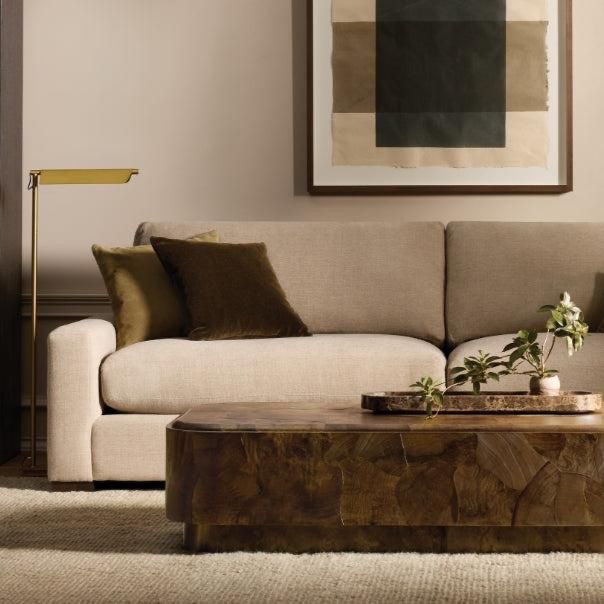 Sofa vignette with brass floor lamp and natural textures