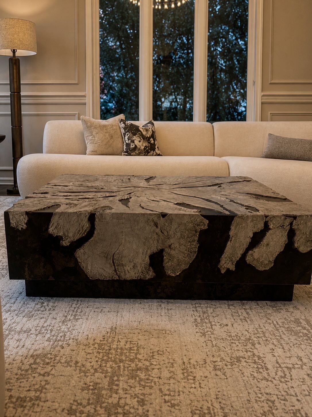 Sculptural coffee table with cream sofa